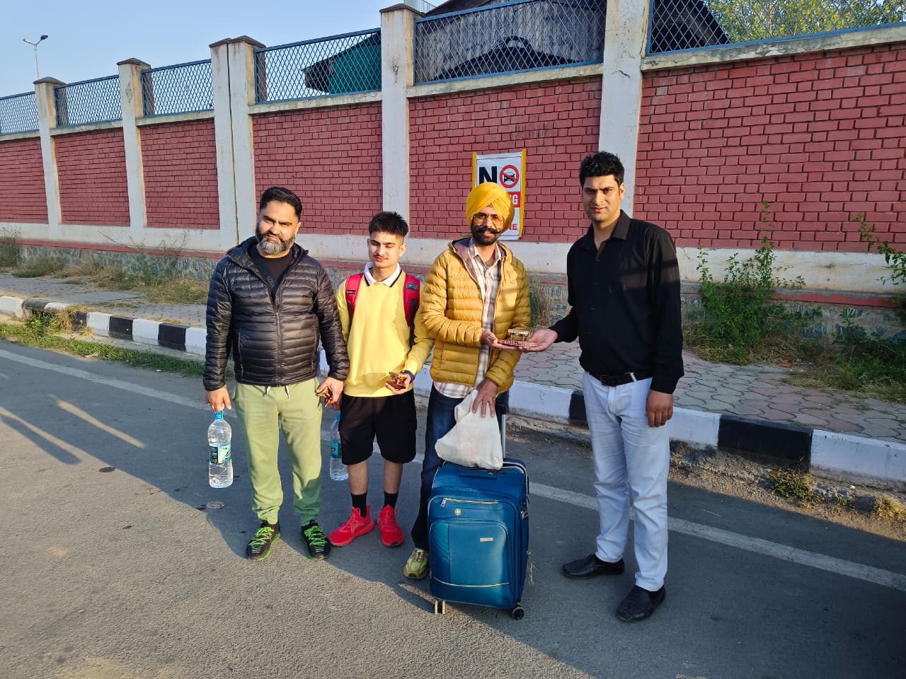 A group of visitors posing together in Kashmir